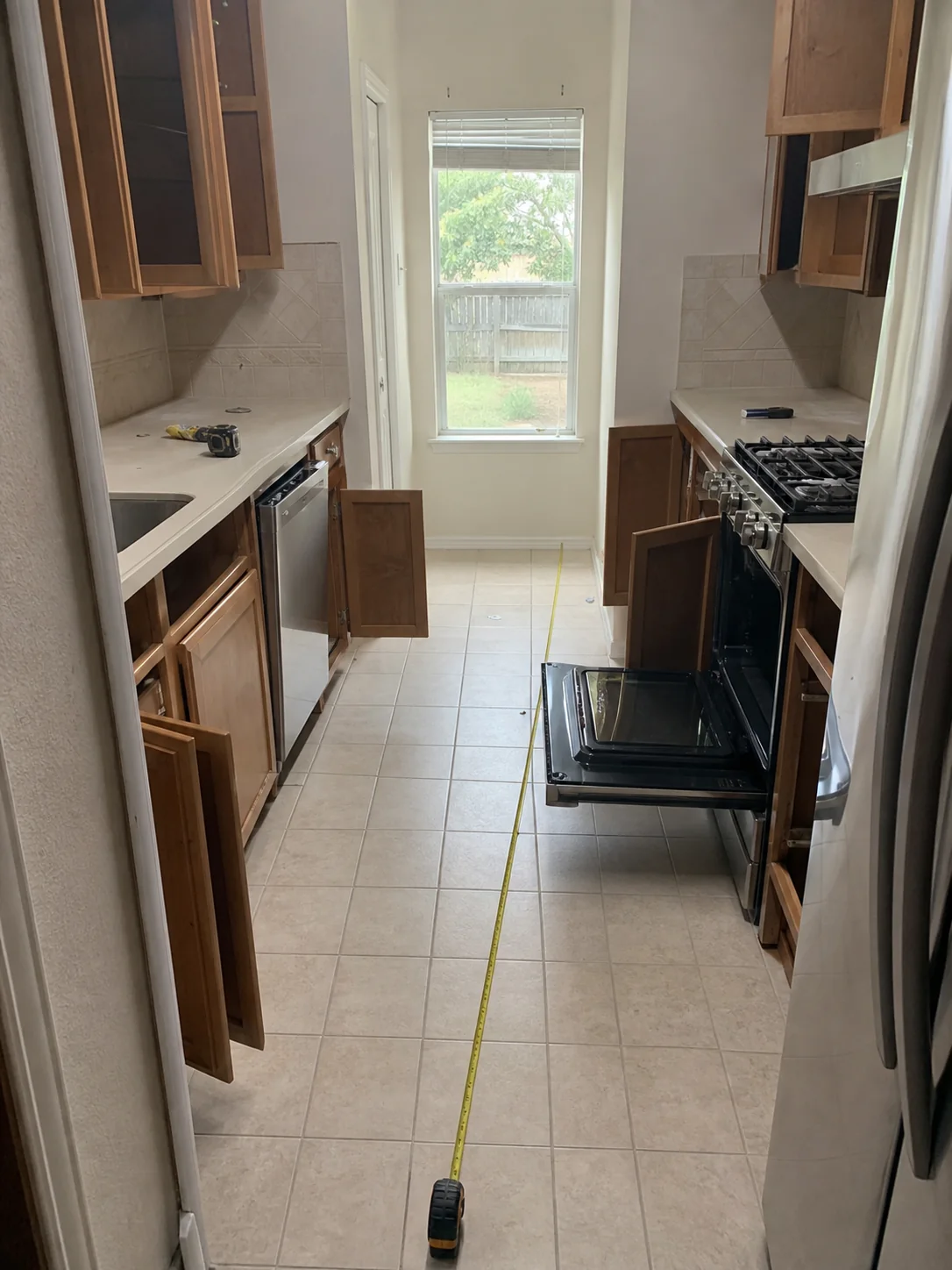 Narrow Dallas galley kitchen being measured before remodeling