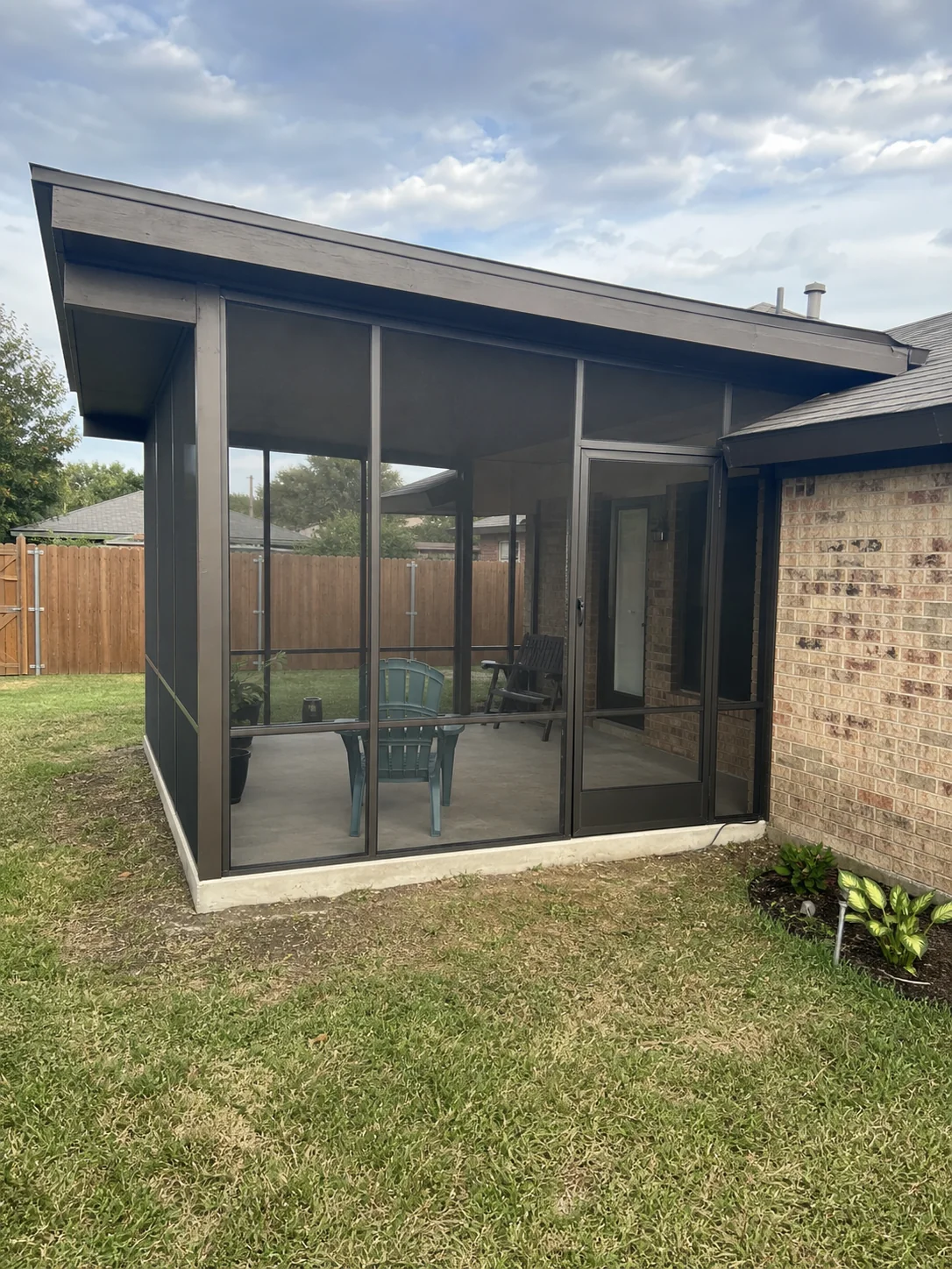 Screened patio enclosure attached to a modest Dallas home