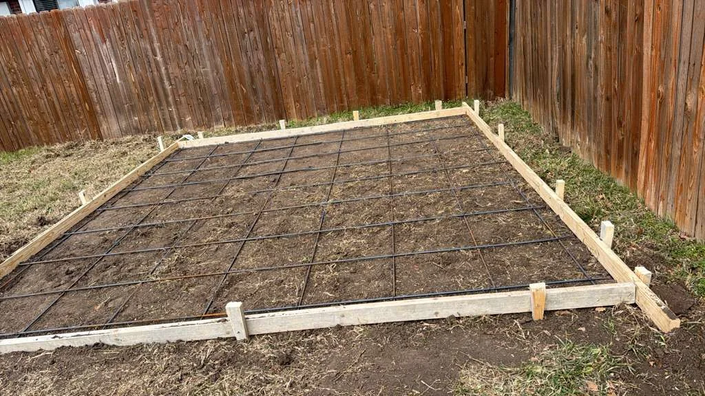 Prepared patio area with forms and reinforcing grid in a Dallas backyard