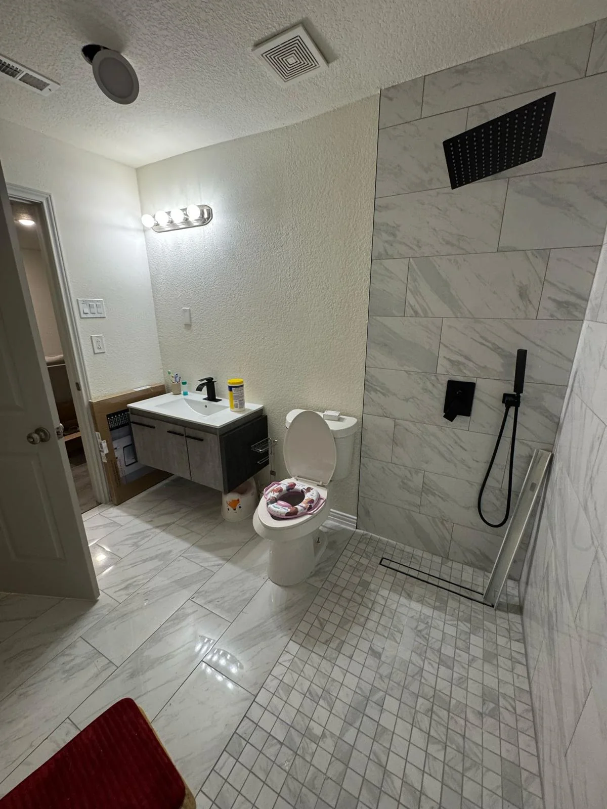 Wide view of a renovated Dallas bathroom with a walk-in shower