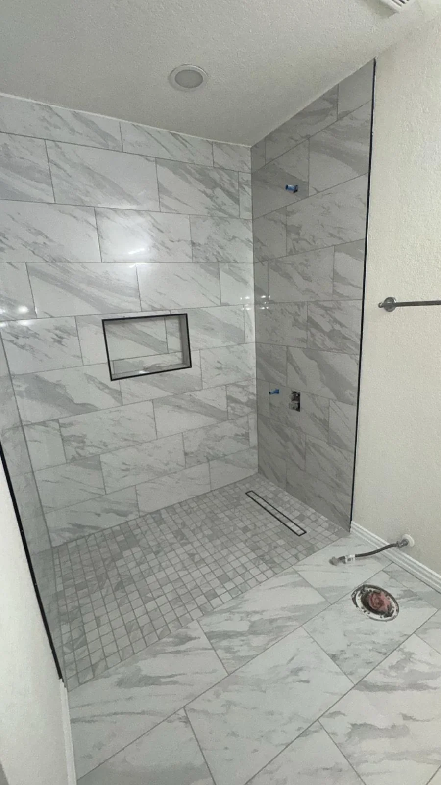 Completed walk-in shower with large tile in a Dallas bathroom remodel